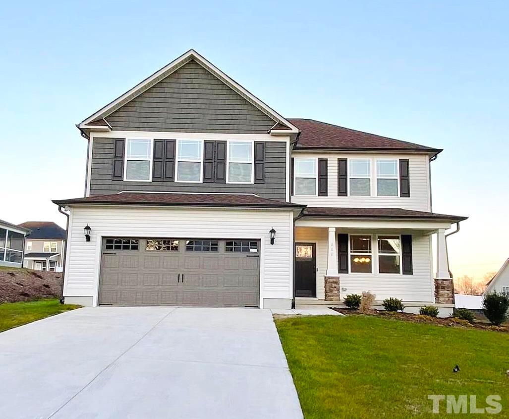111 Tang Circle Garner, NC 27529 - Photo 1 of 16 a front view of a house with a yard and garage