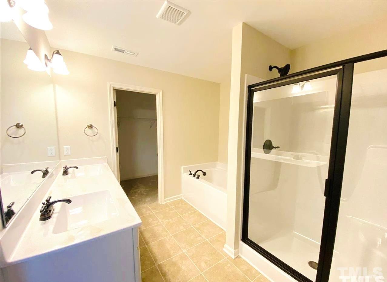 111 Tang Circle Garner, NC 27529 - Photo 4 of 16 a bathroom with a shower sink and mirror