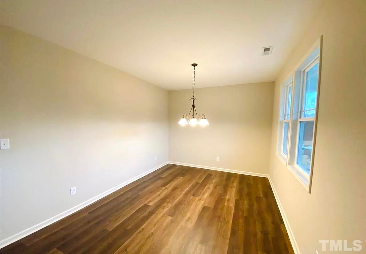 111 Tang Circle Garner, NC 27529 - Photo 7 of 16 a view of empty room with wooden floor and fan