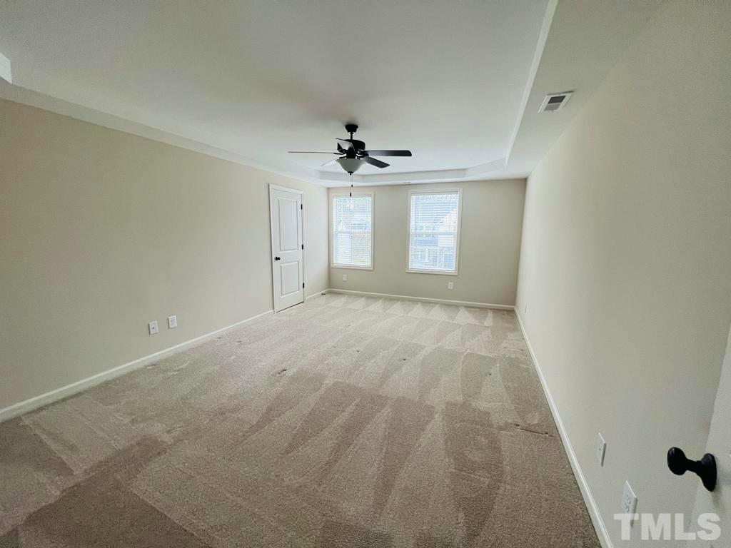 111 Tang Circle Garner, NC 27529 - Photo 9 of 16 an empty room with windows and ceiling fan