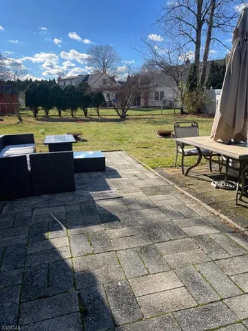 a view of a swimming pool with lounge chairs in the patio