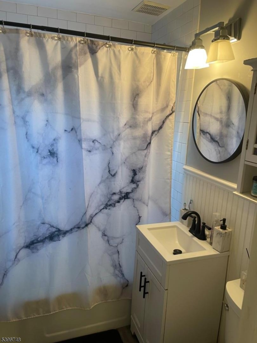 16 Brookside Avenue Pequannock, NJ 07444 - Photo 18 of 30 a bathroom with a sink and a mirror