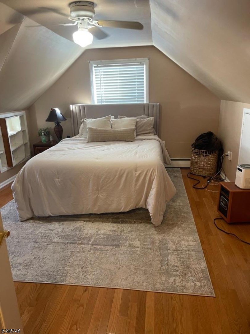 16 Brookside Avenue Pequannock, NJ 07444 - Photo 20 of 30 a bedroom with a bed and lamp with window