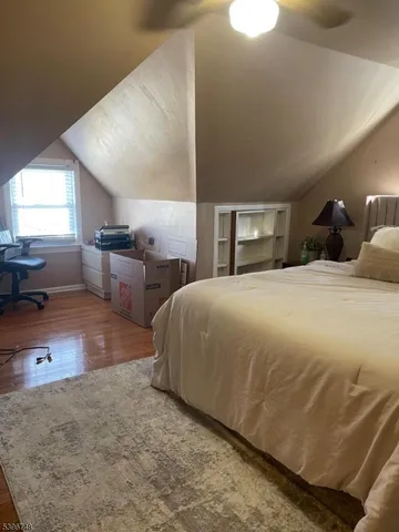 a spacious bedroom with a bed and a large window