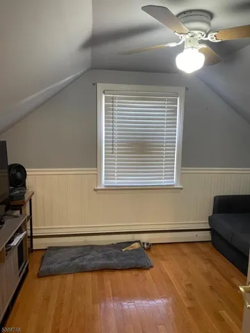 a bedroom with a bed and a ceiling fan