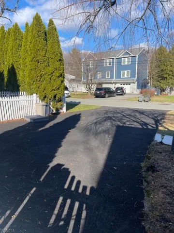 a view of a street with houses on both side of the house