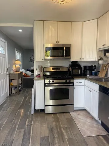 a kitchen with stainless steel appliances a stove a sink and a microwave