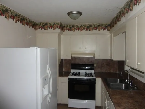 a kitchen with a stove and a refrigerator
