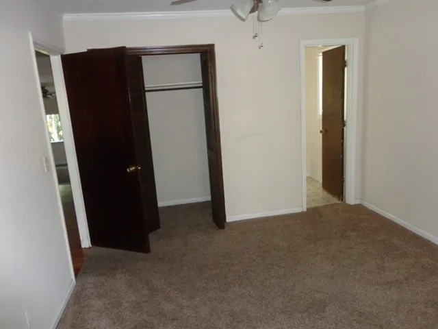 an empty room with closet and door