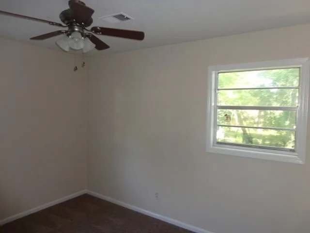 a small space with a window and a fan