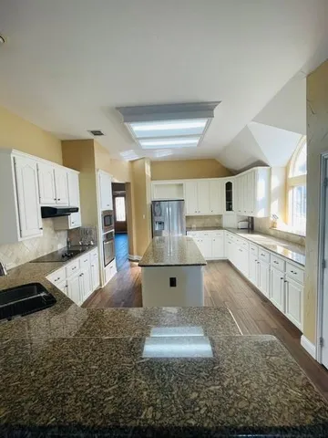 a large kitchen with cabinets