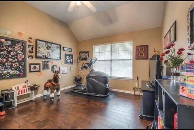 a view of a livingroom with workspace and a window