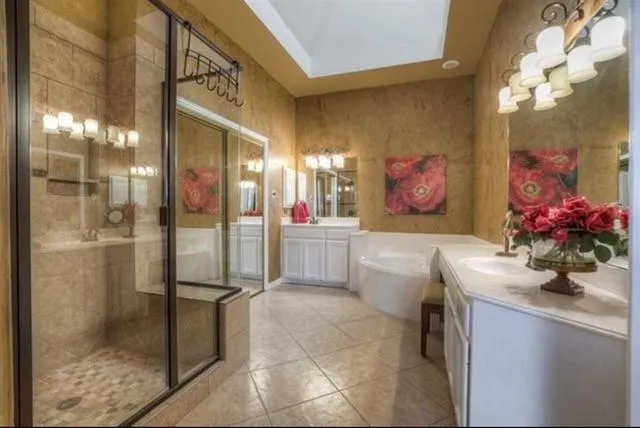 a bathroom with a double vanity sink mirror and shower