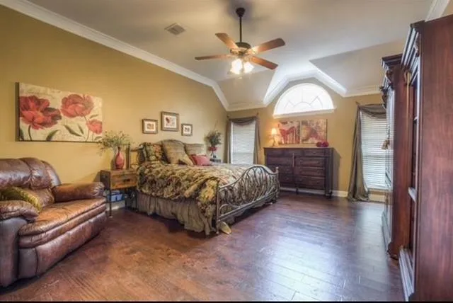 a spacious bedroom with a bed window and a chandelier