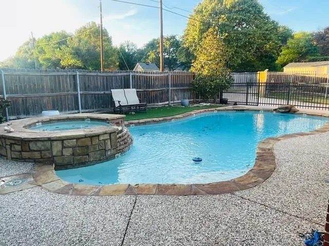 a view of a backyard with a small pool