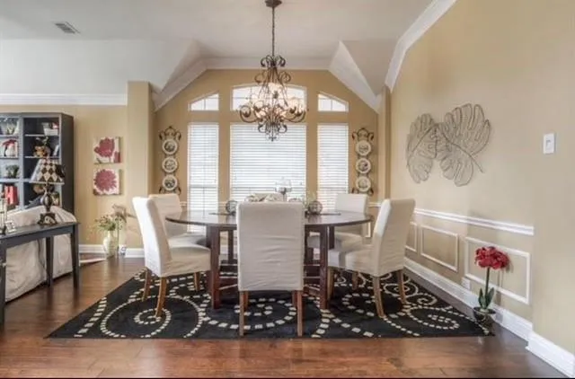 a view of a dining room with furniture and a chandelier