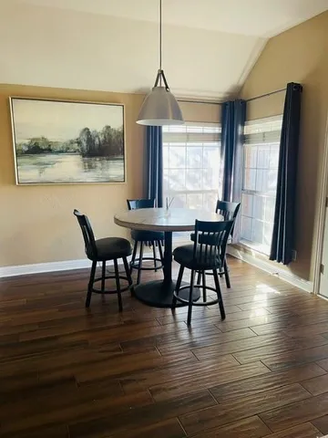 a dining room with furniture window wooden floor