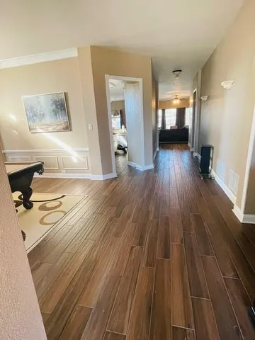a view of a living room hardwood floor and a kitchen