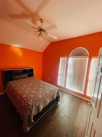 a bed sitting in a bedroom next to a window