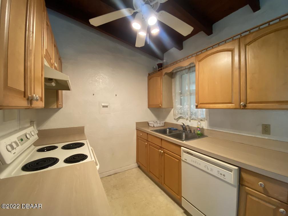 114 Essex Drive Ormond Beach, FL 32176 - Photo 11 of 21 a kitchen with a sink a stove and cabinets