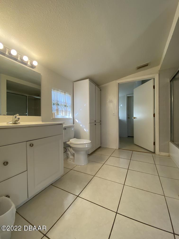 114 Essex Drive Ormond Beach, FL 32176 - Photo 15 of 21 a spacious bathroom with a mirror and a sink