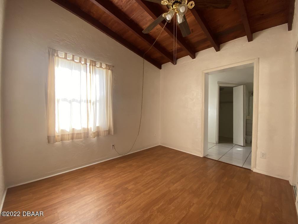 114 Essex Drive Ormond Beach, FL 32176 - Photo 17 of 21 a view of empty room with wooden floor and fan