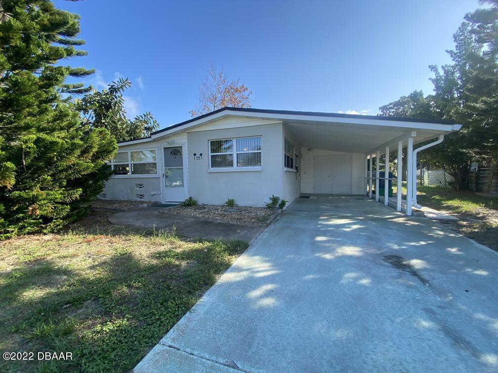 114 Essex Drive Ormond Beach, FL 32176 - Photo 2 of 21 a front view of a house with a yard