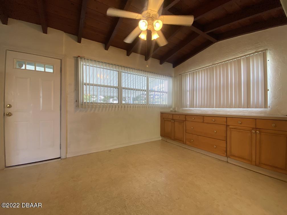 114 Essex Drive Ormond Beach, FL 32176 - Photo 7 of 21 a view of an empty room with window and chandelier fan