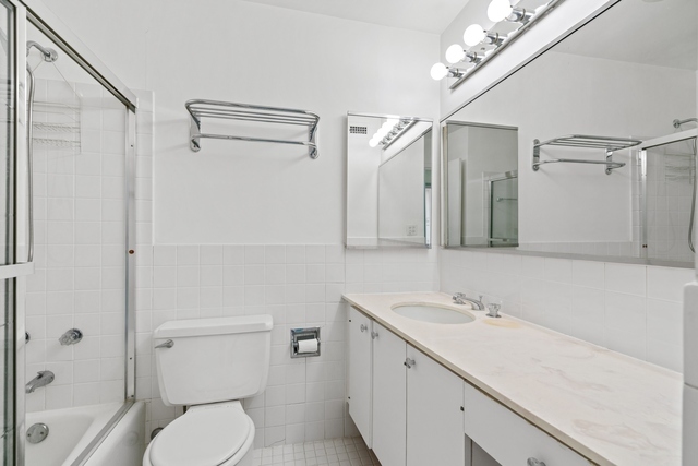 5455 North Sheridan Road, Unit 2301 Chicago, IL 60640 - Photo 11 of 18 a bathroom with a sink a toilet and shower
