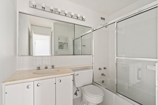 5455 North Sheridan Road, Unit 2301 Chicago, IL 60640 - Photo 13 of 18 a bathroom with a granite countertop sink a toilet and shower