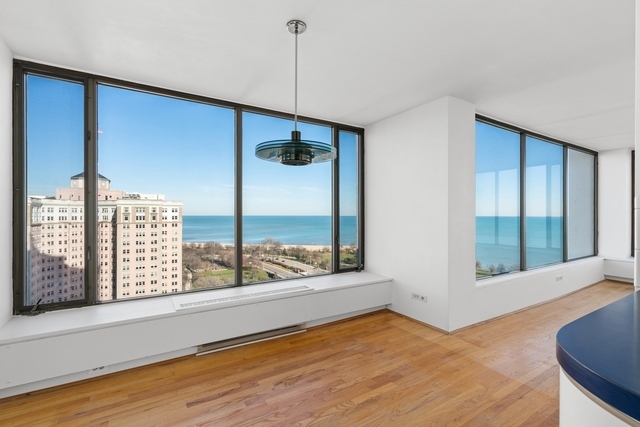 5455 North Sheridan Road, Unit 2301 Chicago, IL 60640 - Photo 8 of 18 a view of an empty room with wooden floor and a window