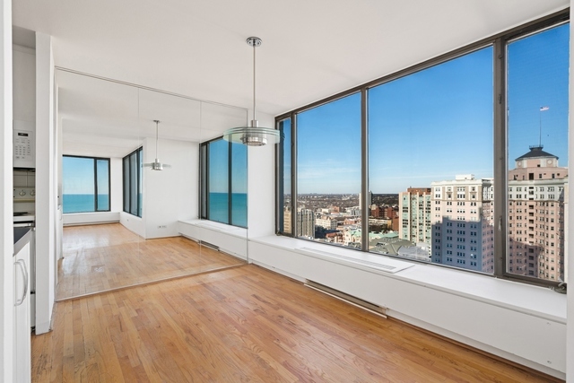 5455 North Sheridan Road, Unit 2301 Chicago, IL 60640 - Photo 9 of 18 a view of an empty room with windows