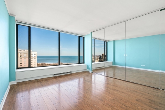 5455 North Sheridan Road, Unit 2301 Chicago, IL 60640 - Photo 10 of 18 a view of empty room with wooden floor and fan