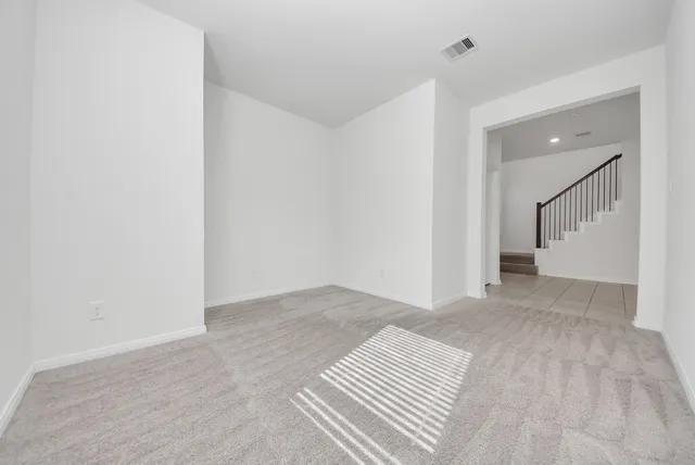 a view of a bedroom with wooden floor and bathroom
