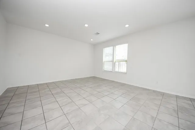an empty room with white walls and tiles