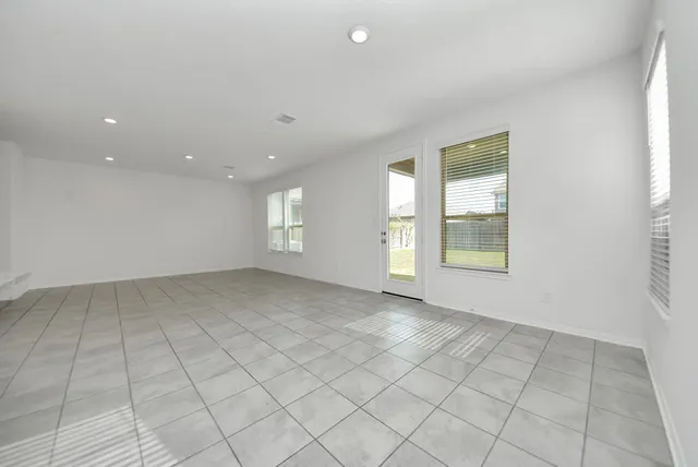 a view of kitchen with granite countertop cabinets a sink and a window