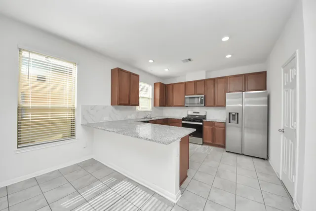a kitchen with a sink stove and refrigerator