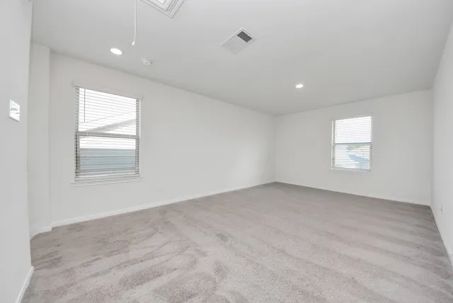 an empty room with windows and closet