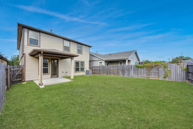 a view of a house with a yard and sitting area
