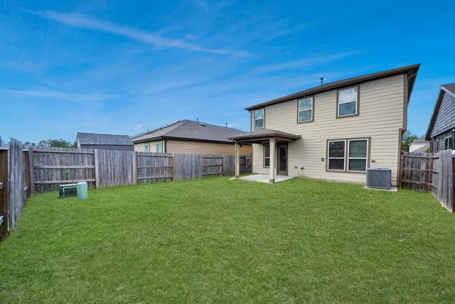 a view of a house with a backyard