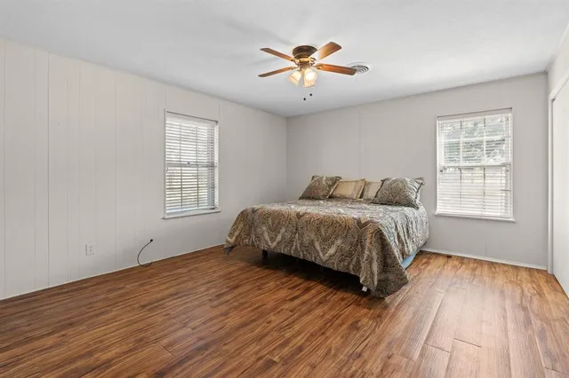 a bedroom with a large bed and a window
