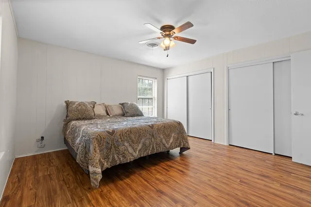 a bedroom with a bed and wooden floor