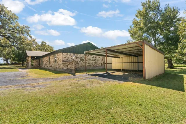 a view of a house with a yard and sitting area