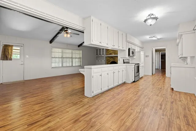 a kitchen with stainless steel appliances a refrigerator and a stove top oven