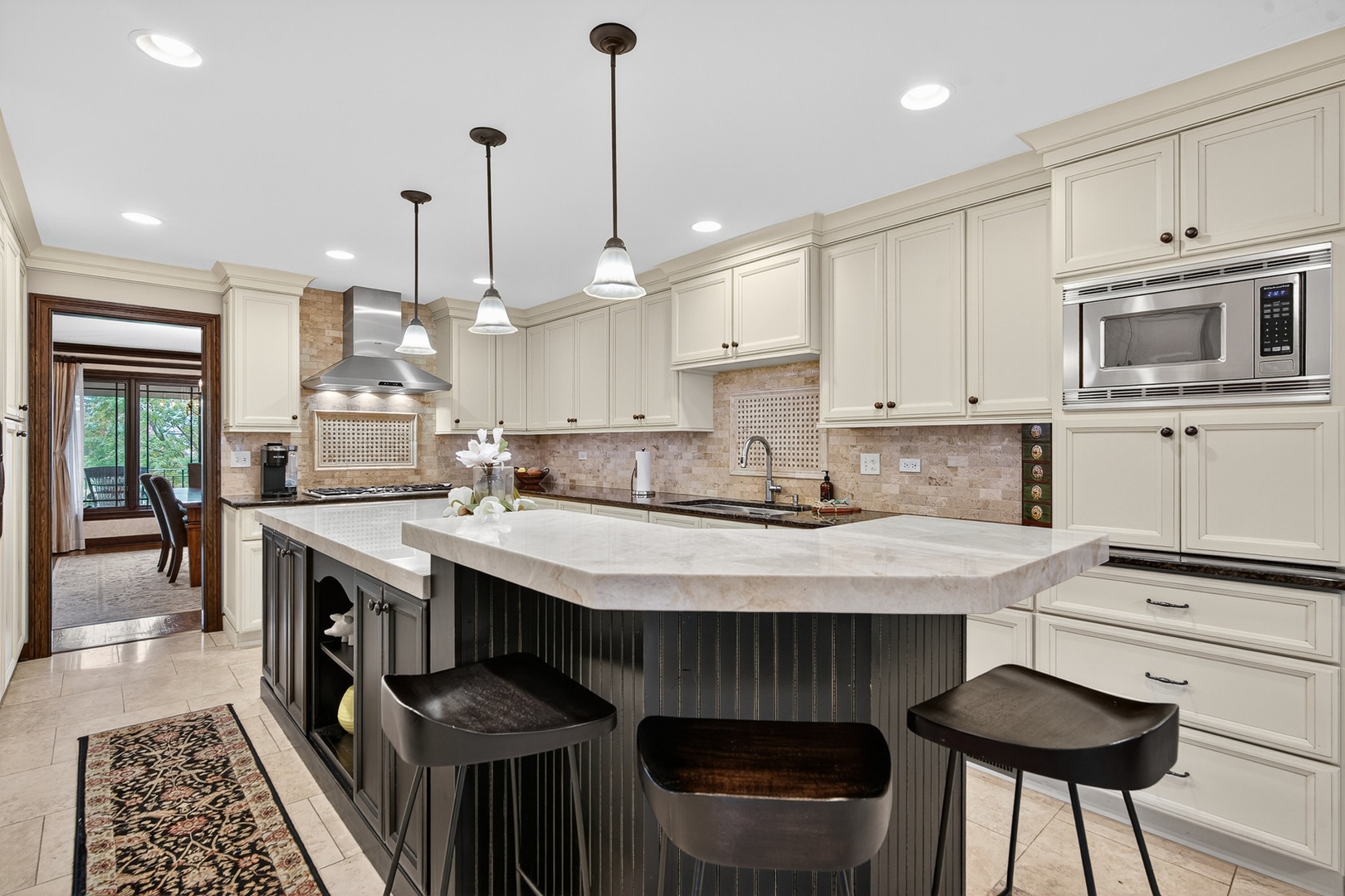 1886 West Clover Drive Inverness, IL 60067 - Photo 5 of 45 a kitchen with stainless steel appliances granite countertop a stove a sink a oven a dining table and chairs