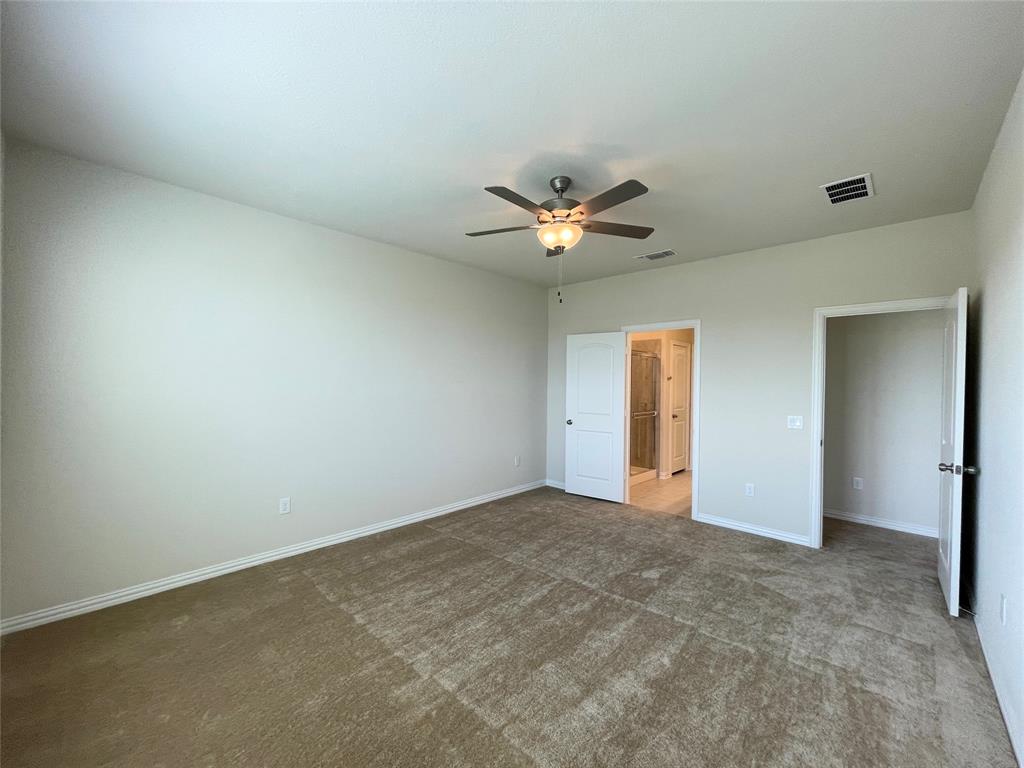 1805 Nelson Street Anna, TX 75409 - Photo 15 of 38 an empty room with a chandelier fan and a window