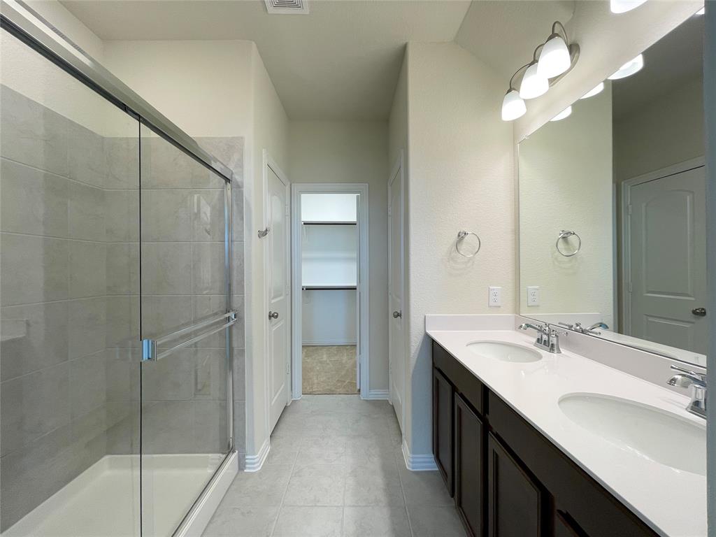 1805 Nelson Street Anna, TX 75409 - Photo 16 of 38 a bathroom with a double vanity sink mirror and shower