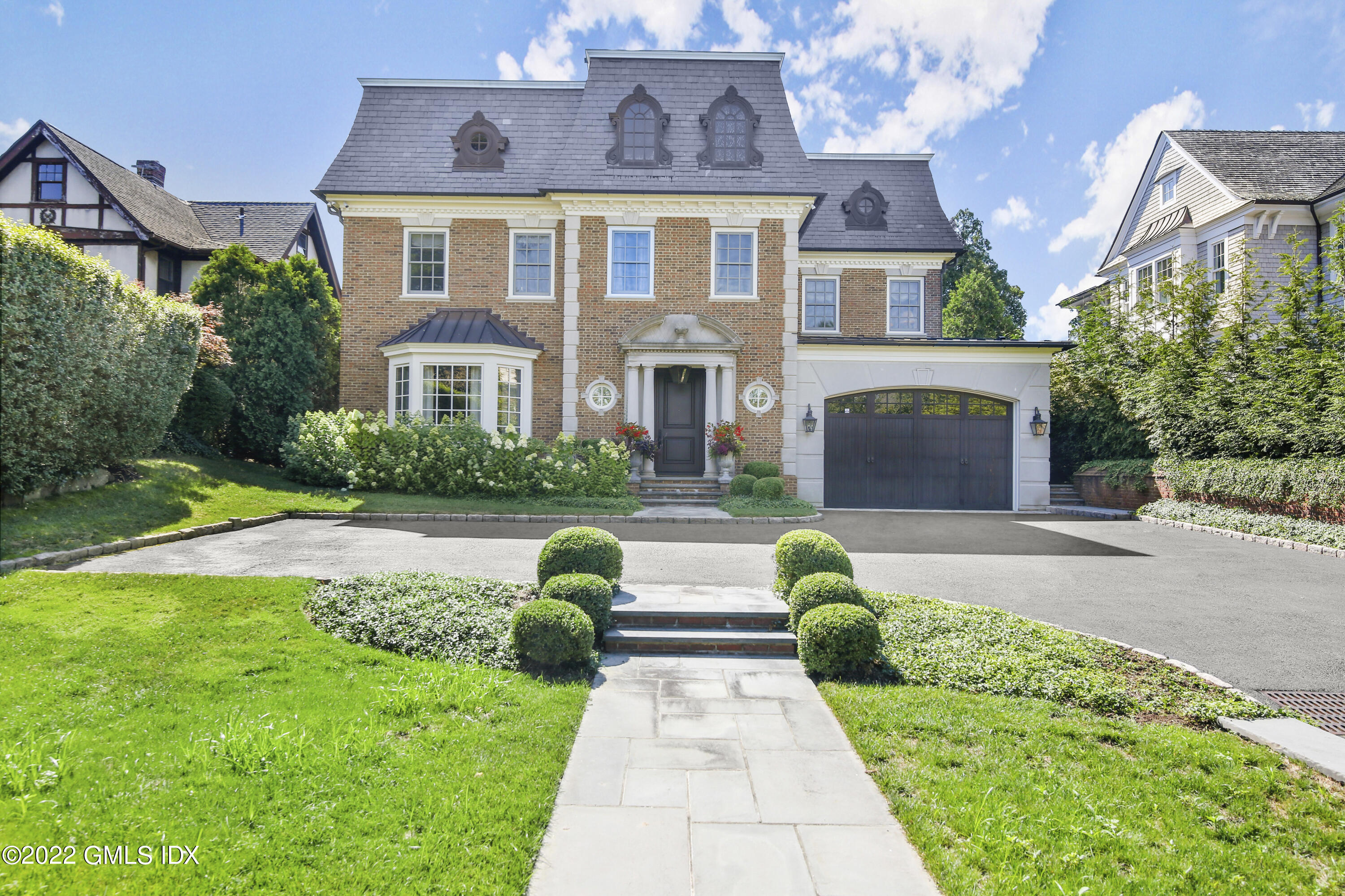 a front view of a house with garden