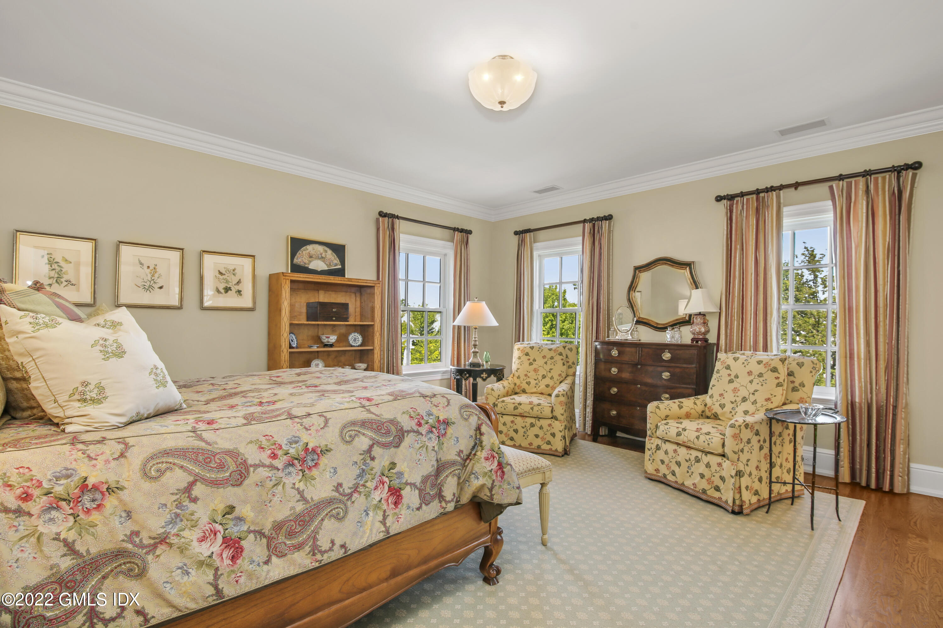 62 Ridge Street Greenwich, CT 06830 - Photo 27 of 40 a bedroom with bed and large windows