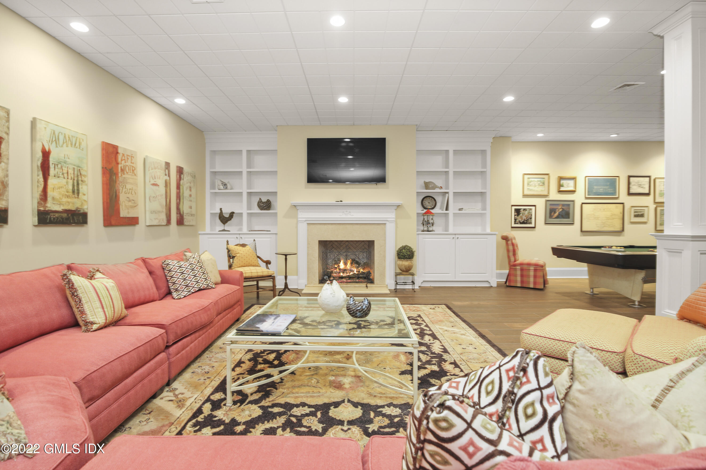 62 Ridge Street Greenwich, CT 06830 - Photo 31 of 40 a living room with fireplace furniture and a flat screen tv